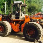 bulldozer before industrial sandblasting with rust and peeling paint