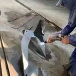 Paint removal of a large part of a boat through sandblasting