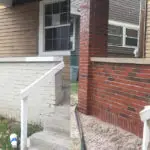 Before and after image of a red brick residential home after mobile sandblasting to remove the white paint from the brick